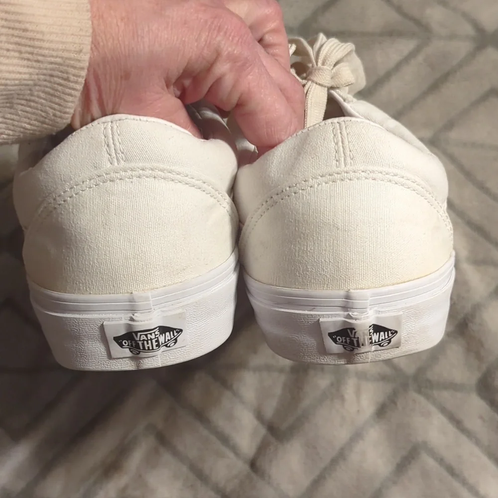 Vans Old Skool shoes in the True White or Monochrome‎ White colorway.